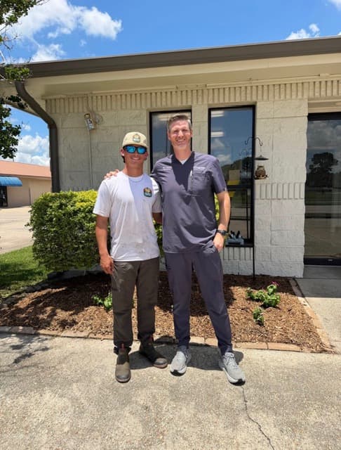 Southern Bayou Lawn owner with happy commercial client Louisiana